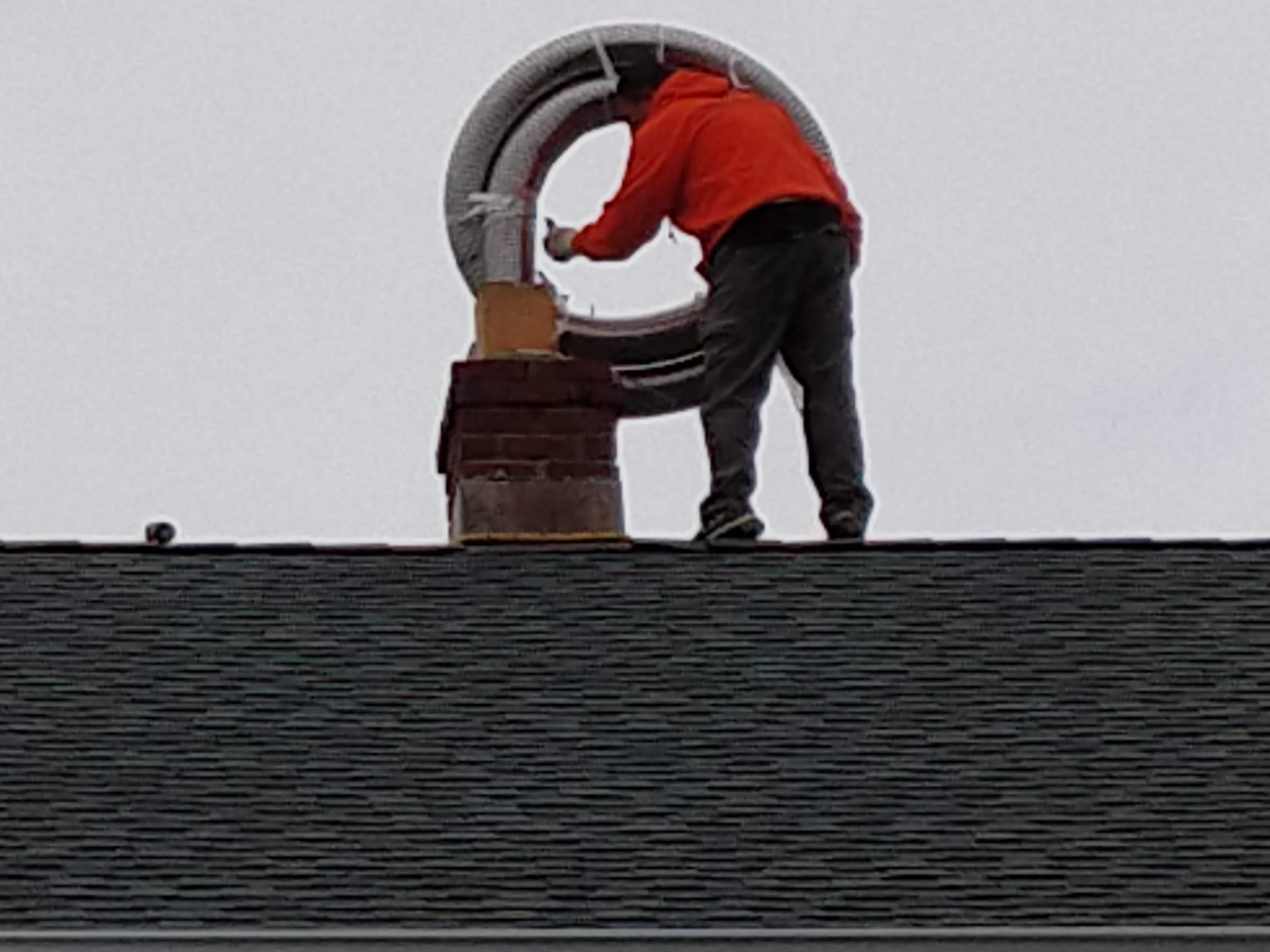 Flexible stainless chimney liner being installed in Elmont, New York